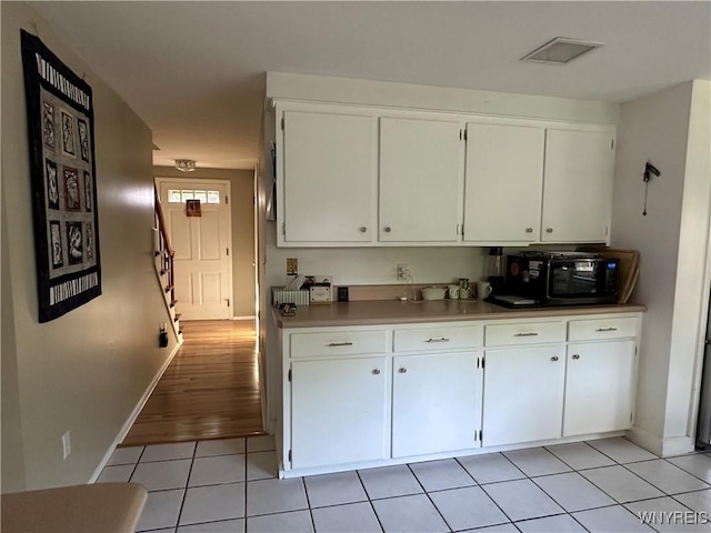 4214 Wilson Burt Rd, Wilson, NY 14172 - kitchen with black microwave and white cabinetry