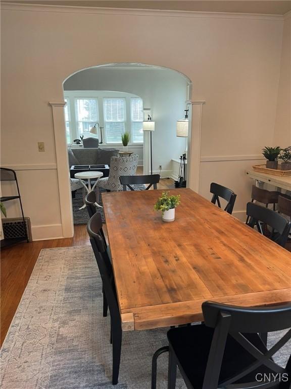 336 Hickok Ave, Syracuse, NY 13206 - dining room featuring arched walkways, wood finished floors, and crown molding