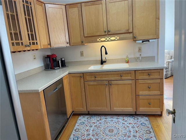 336 Hickok Ave, Syracuse, NY 13206 - kitchen with stainless steel dishwasher, light wood-style flooring, light countertops, and glass insert cabinets