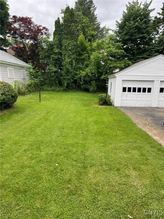 336 Hickok Ave, Syracuse, NY 13206 - view of grassy yard with a garage and an outdoor structure