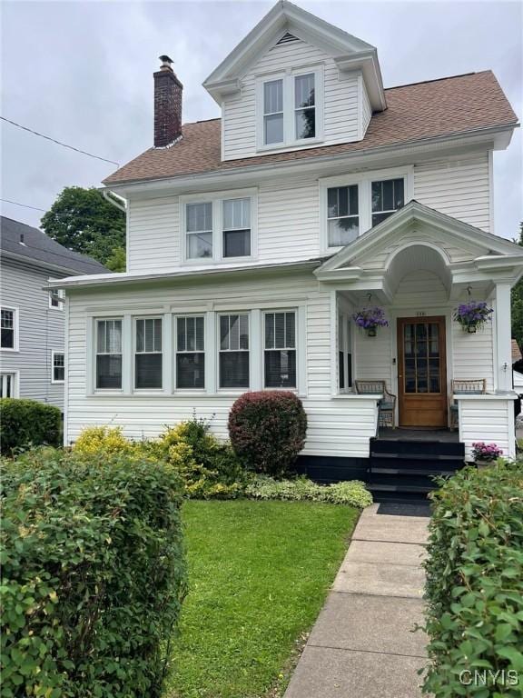 336 Hickok Ave, Syracuse, NY 13206 - traditional style home with a chimney, a front yard, and a shingled roof