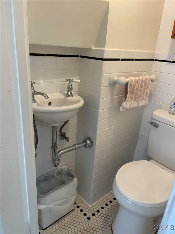 336 Hickok Ave, Syracuse, NY 13206 - bathroom featuring tile walls, tile patterned floors, and a wainscoted wall