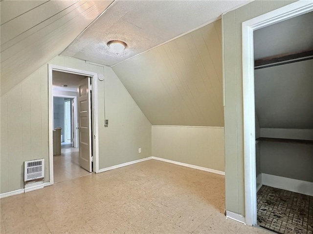 60 Clairmount St, Rochester, NY 14621 - additional living space with tile patterned floors, heating unit, and vaulted ceiling