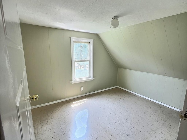 60 Clairmount St, Rochester, NY 14621 - additional living space with tile patterned floors and vaulted ceiling