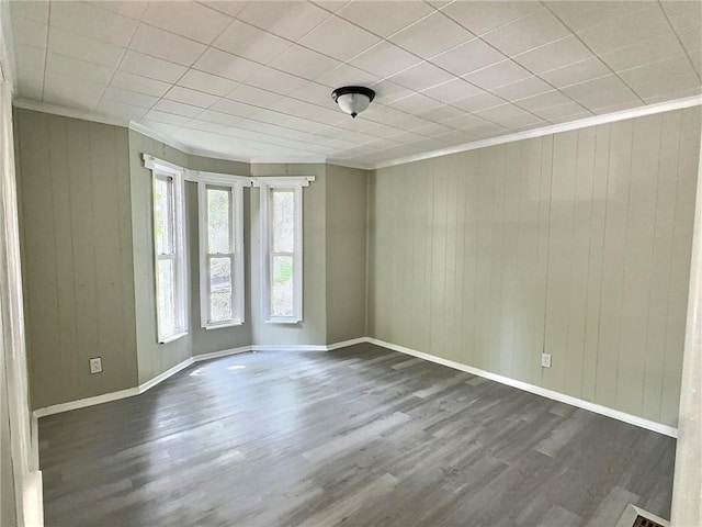 60 Clairmount St, Rochester, NY 14621 - spare room featuring dark wood finished floors, wooden walls, and ornamental molding