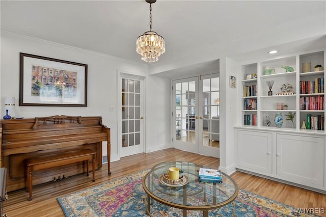 580 Roycroft Blvd, Cheektowaga, NY 14225 - sitting room featuring french doors, light wood-style flooring, a chandelier, and ornamental molding