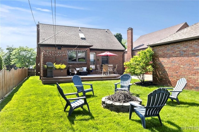 580 Roycroft Blvd, Cheektowaga, NY 14225 - rear view of house featuring a fire pit, a deck, a shingled roof, and brick siding