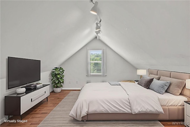 580 Roycroft Blvd, Cheektowaga, NY 14225 - bedroom featuring rail lighting, wood finished floors, and lofted ceiling