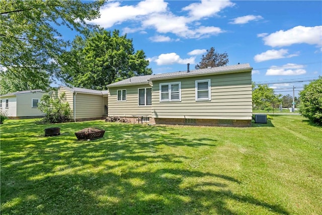970 Elmgrove Rd, Gates, NY 14624 - rear view of house with an outdoor fire pit and a lawn