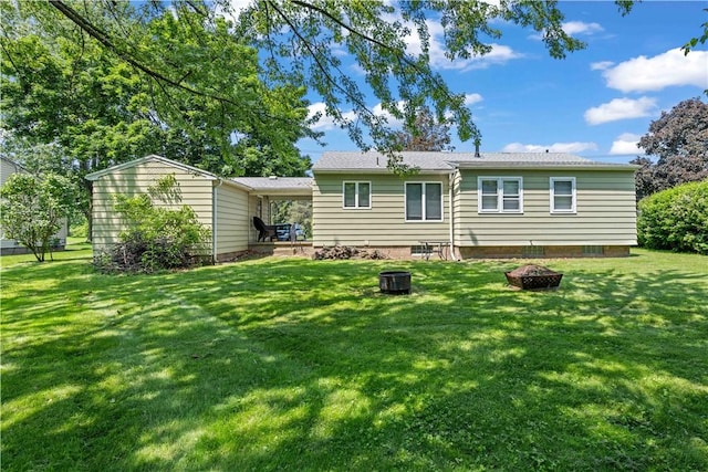 970 Elmgrove Rd, Gates, NY 14624 - rear view of property with an outdoor fire pit and a lawn