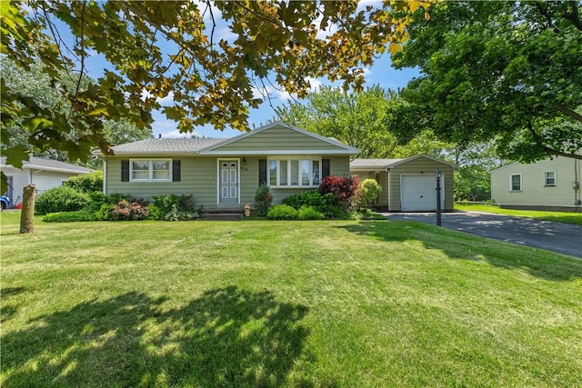 970 Elmgrove Rd, Gates, NY 14624 - single story home with asphalt driveway, an attached garage, and a front yard