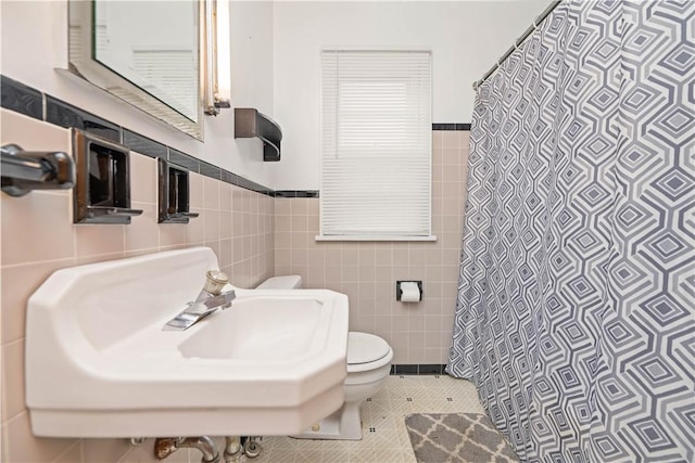 970 Elmgrove Rd, Gates, NY 14624 - bathroom featuring tile walls, curtained shower, and a wainscoted wall