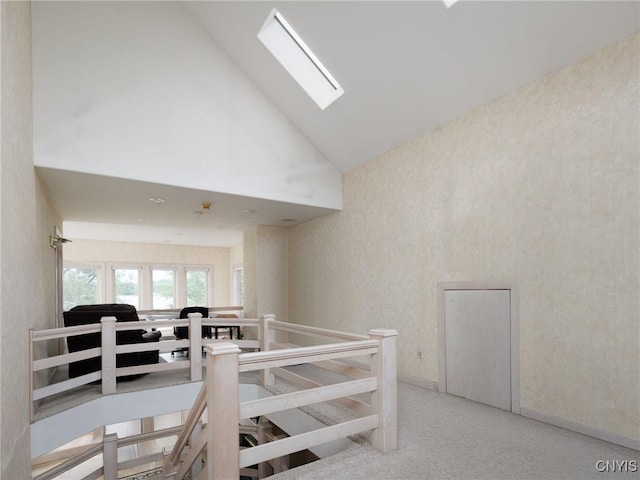 21751 Hewitt Dr, Champion, NY 13619 - staircase with high vaulted ceiling, a skylight, carpet floors, and wallpapered walls