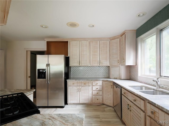 21751 Hewitt Dr, Champion, NY 13619 - kitchen featuring appliances with stainless steel finishes, backsplash, light wood-style floors, light stone counters, and recessed lighting