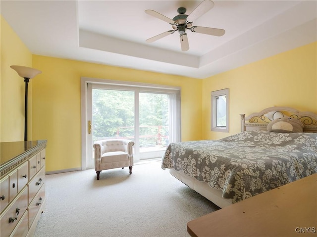 21751 Hewitt Dr, Champion, NY 13619 - bedroom with carpet, access to outside, a tray ceiling, and a ceiling fan