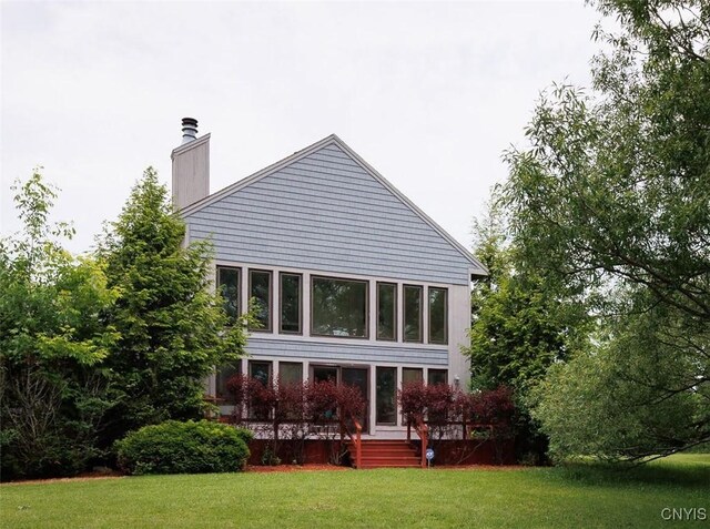 21751 Hewitt Dr, Champion, NY 13619 - rear view of property featuring a chimney and a yard