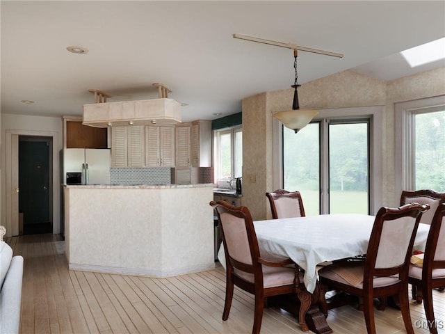21751 Hewitt Dr, Champion, NY 13619 - dining area featuring light wood-type flooring, healthy amount of natural light, and a skylight