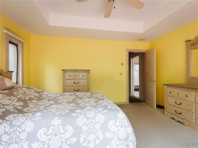 21751 Hewitt Dr, Champion, NY 13619 - bedroom with light colored carpet, a tray ceiling, and a ceiling fan