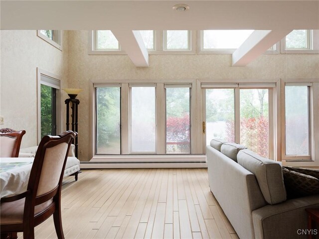 21751 Hewitt Dr, Champion, NY 13619 - living area with light wood finished floors, a towering ceiling, and a skylight
