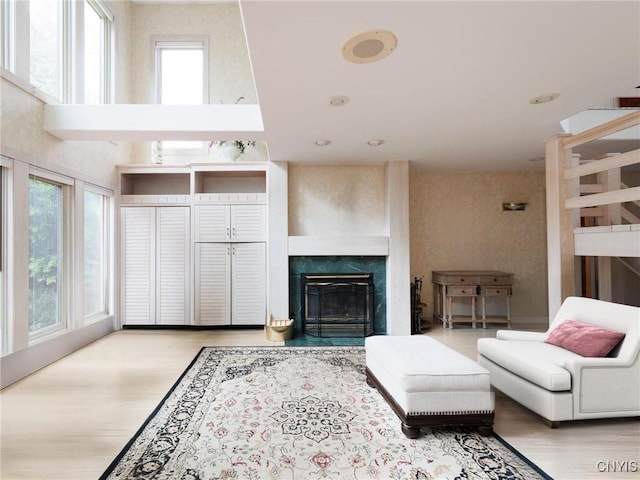 21751 Hewitt Dr, Champion, NY 13619 - living room with plenty of natural light, wood finished floors, and a glass covered fireplace