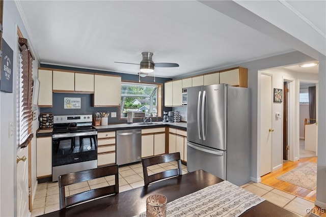 120 Gordon Rd, Clay, NY 13212 - kitchen with stainless steel appliances, a ceiling fan, dark countertops, cream cabinets, and light tile patterned floors