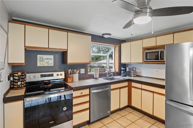 120 Gordon Rd, Clay, NY 13212 - kitchen featuring stainless steel appliances, cream cabinetry, tile countertops, crown molding, and ceiling fan
