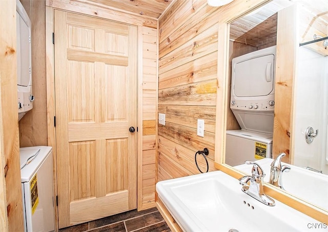 5345 Paddleford Rd, Eaton, NY 13334 - bathroom featuring stacked washing machine and dryer and wood walls