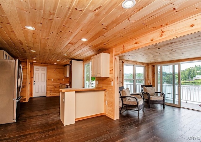 5345 Paddleford Rd, Eaton, NY 13334 - kitchen featuring freestanding refrigerator, dark wood finished floors, wooden walls, recessed lighting, and a peninsula