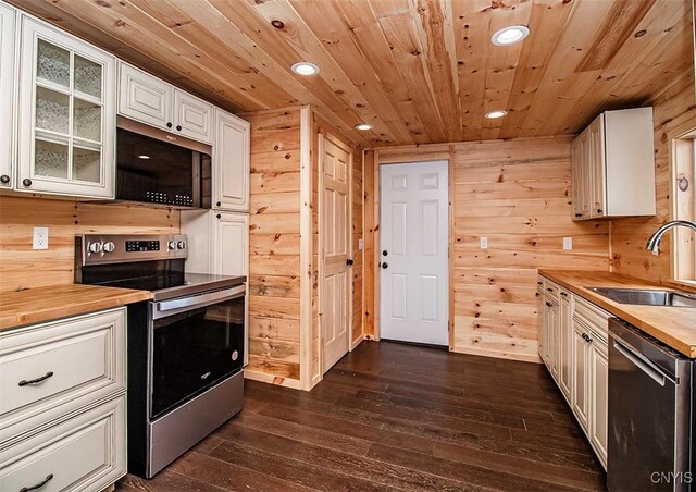 5345 Paddleford Rd, Eaton, NY 13334 - kitchen featuring stainless steel appliances, butcher block countertops, dark wood finished floors, recessed lighting, and wood walls