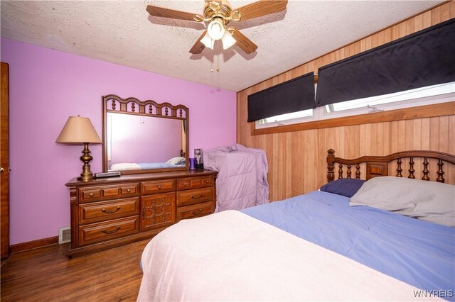 241 Shanley St, Cheektowaga, NY 14206 - bedroom with wood finished floors, a textured ceiling, wood walls, and ceiling fan