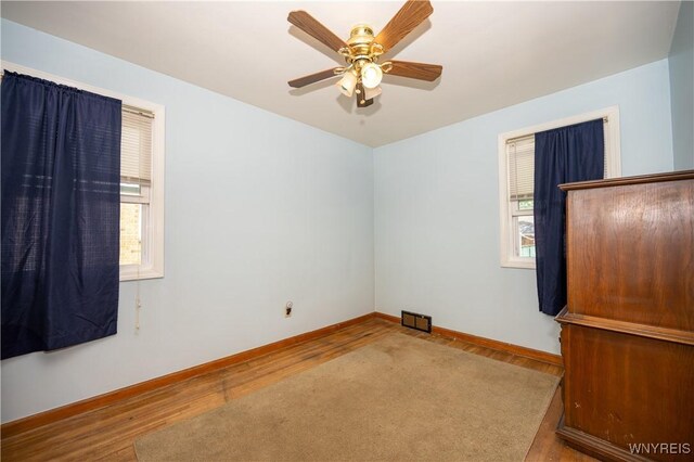 241 Shanley St, Cheektowaga, NY 14206 - empty room with healthy amount of natural light, wood finished floors, and ceiling fan
