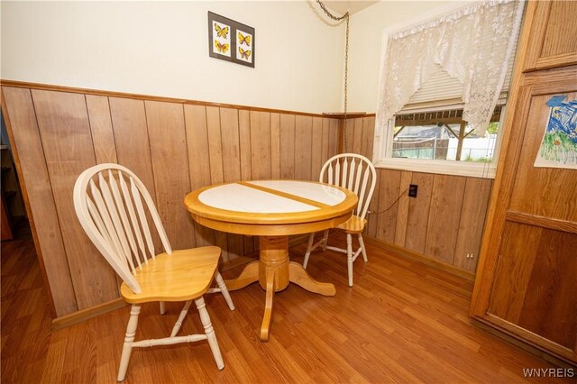 241 Shanley St, Cheektowaga, NY 14206 - dining room with wood walls, wood finished floors, and a wainscoted wall