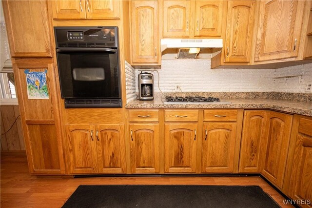241 Shanley St, Cheektowaga, NY 14206 - kitchen with oven, under cabinet range hood, decorative backsplash, and light wood-type flooring