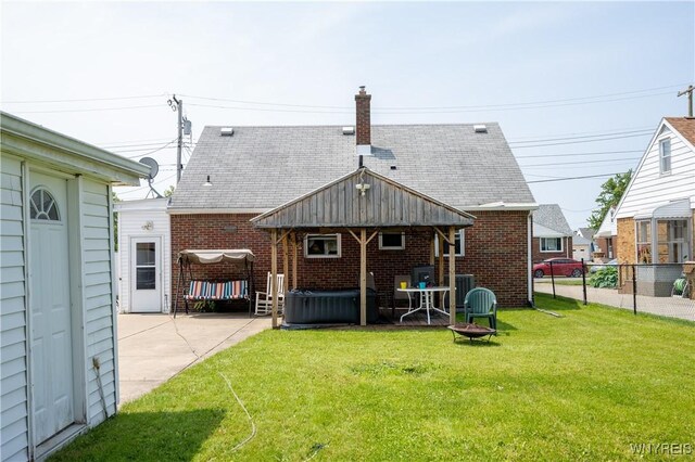 241 Shanley St, Cheektowaga, NY 14206 - rear view of property with a hot tub, a patio area, brick siding, a chimney, and a fire pit