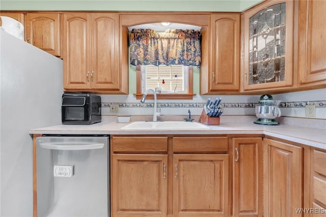 749 Colvin Blvd, Tonawanda-Town, NY 14217 - kitchen with stainless steel dishwasher, light countertops, glass insert cabinets, decorative backsplash, and freestanding refrigerator
