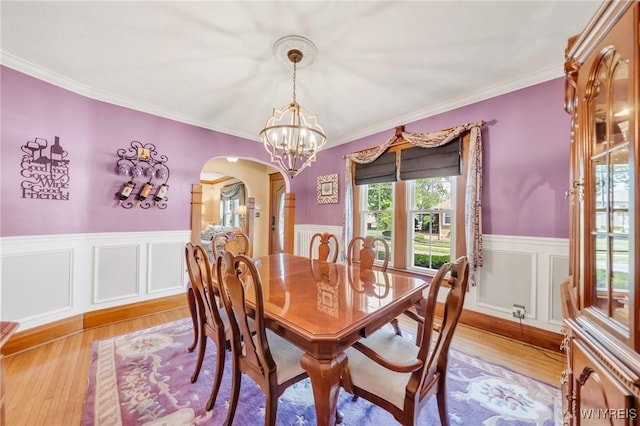 749 Colvin Blvd, Tonawanda-Town, NY 14217 - dining area featuring arched walkways, wainscoting, a chandelier, wood finished floors, and ornamental molding