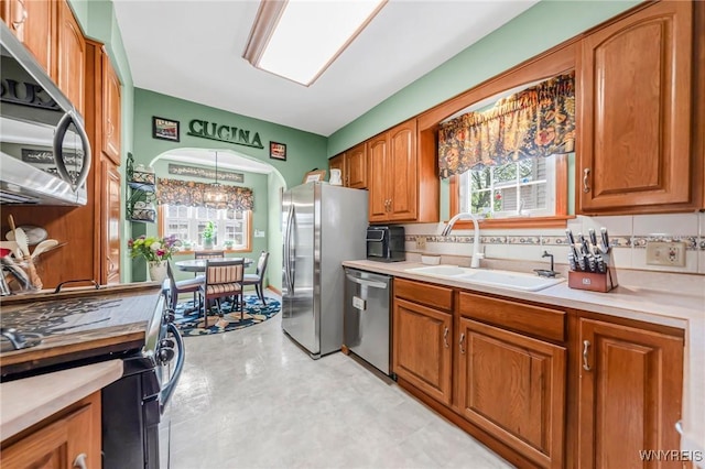 749 Colvin Blvd, Tonawanda-Town, NY 14217 - kitchen featuring appliances with stainless steel finishes, brown cabinetry, light countertops, light flooring, and tasteful backsplash