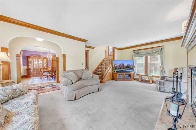 749 Colvin Blvd, Tonawanda-Town, NY 14217 - carpeted living room with arched walkways, ornamental molding, stairs, and a chandelier