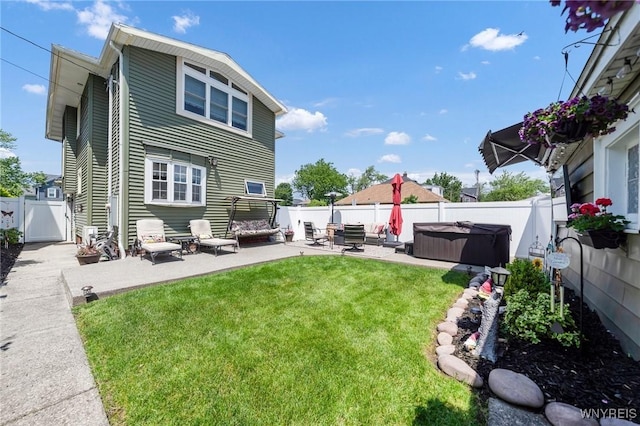 749 Colvin Blvd, Tonawanda-Town, NY 14217 - back of property with a hot tub, a patio area, a fenced backyard, and a gate