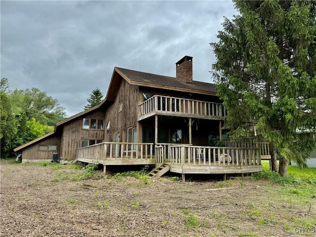 2600 Abend Pt, Marcellus, NY 13110 - rear view of house featuring a chimney and a deck
