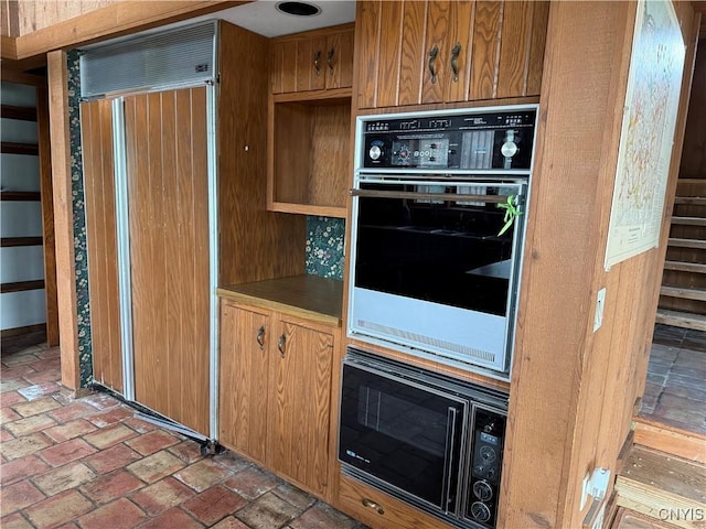 2600 Abend Pt, Marcellus, NY 13110 - kitchen featuring black appliances, brick flooring, and brown cabinets