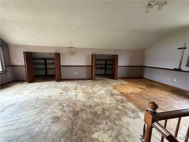 2600 Abend Pt, Marcellus, NY 13110 - unfurnished living room featuring vaulted ceiling and baseboards