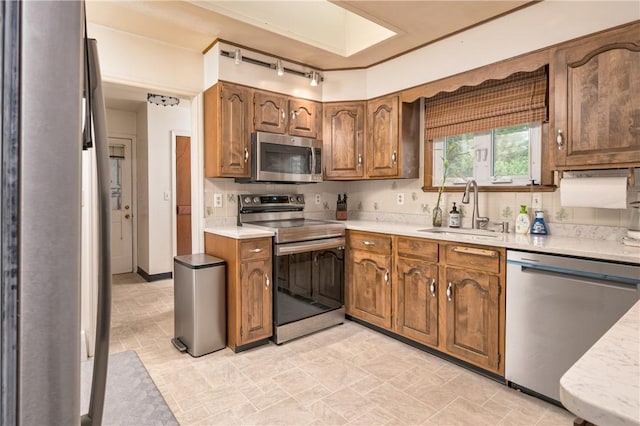22 Bugbee Rd, Oneonta-City, NY 13820 - kitchen featuring appliances with stainless steel finishes, light countertops, brown cabinetry, and track lighting