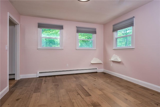 22 Bugbee Rd, Oneonta-City, NY 13820 - unfurnished bedroom with baseboard heating, wood finished floors, and multiple windows