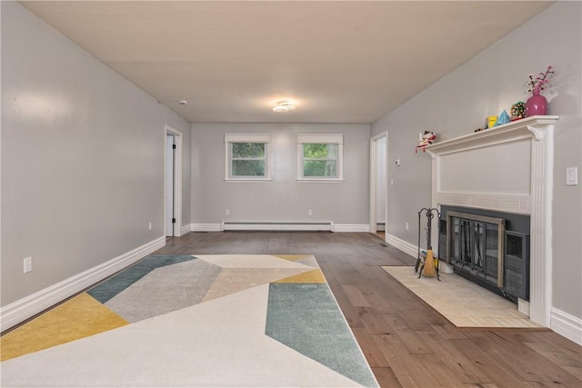 22 Bugbee Rd, Oneonta-City, NY 13820 - unfurnished living room with a fireplace with flush hearth, a baseboard radiator, and wood finished floors