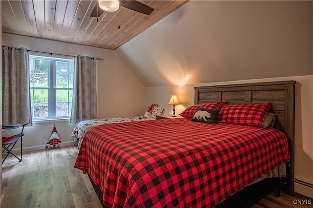 142 S Shore Rd, Webb, NY 13420 - bedroom with a baseboard radiator, wood finished floors, vaulted ceiling, and a ceiling fan