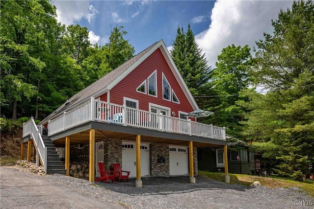 142 S Shore Rd, Webb, NY 13420 - chalet / cabin with a wooden deck, stone siding, a garage, and driveway