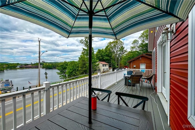 142 S Shore Rd, Webb, NY 13420 - wooden terrace featuring a water view and outdoor dining area