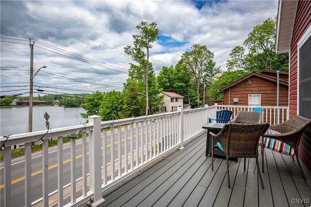 142 S Shore Rd, Webb, NY 13420 - wooden deck with a water view and view of scattered trees