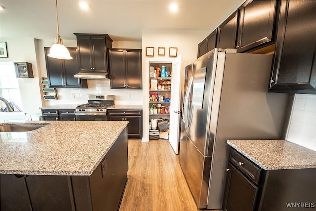 510 Limestone Ct, Grand Island, NY 14072 - kitchen with stainless steel appliances, light wood finished floors, backsplash, light stone counters, and under cabinet range hood